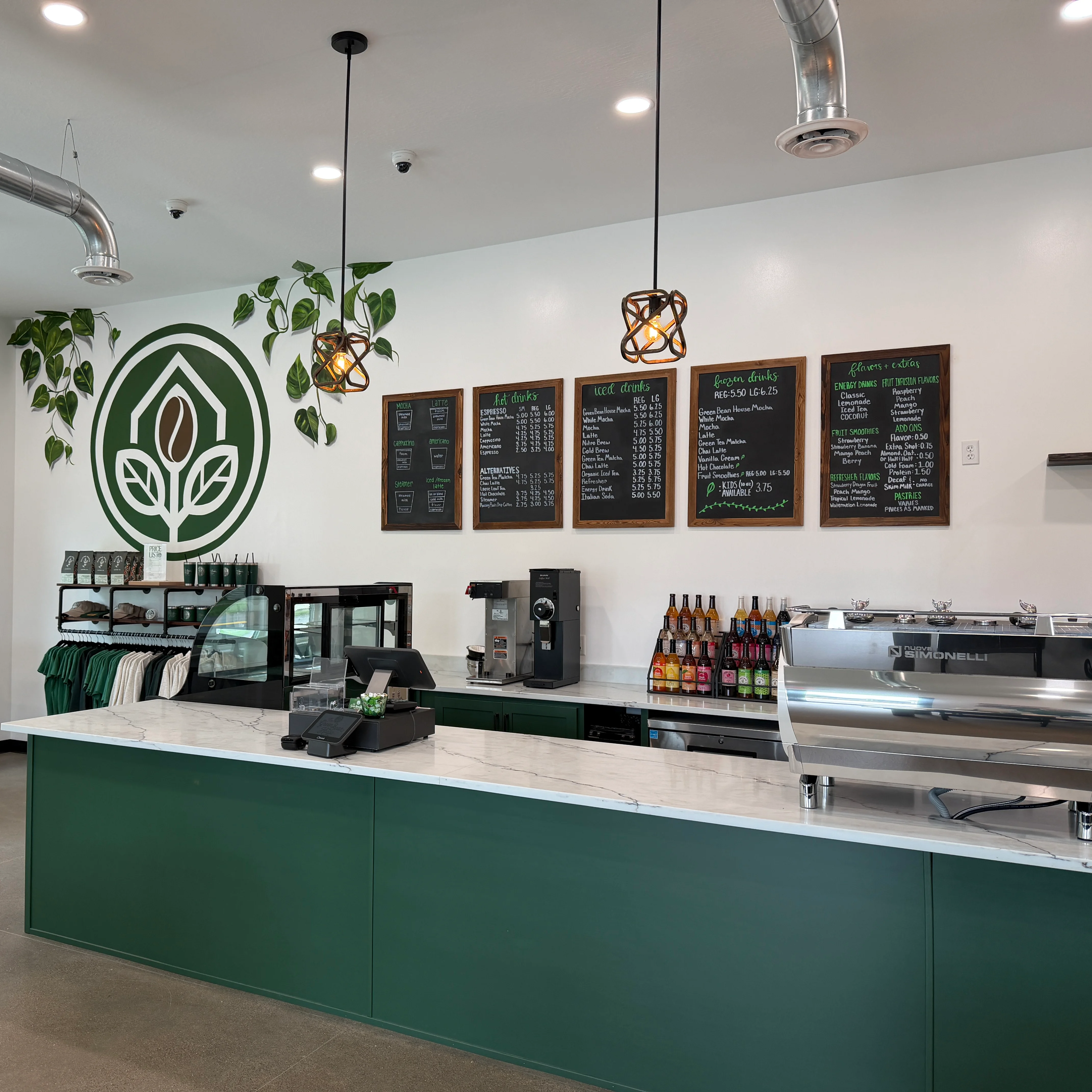 Modern café interior with green accents and menu boards