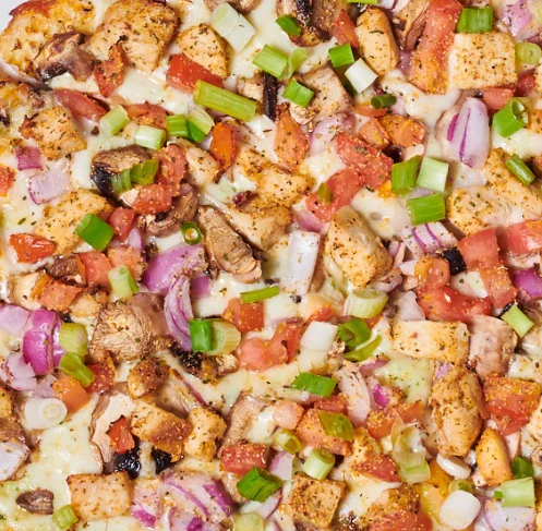 Garlic Chicken pizza with red onions, tomatoes topped with green onions from namaste pizza in oakland