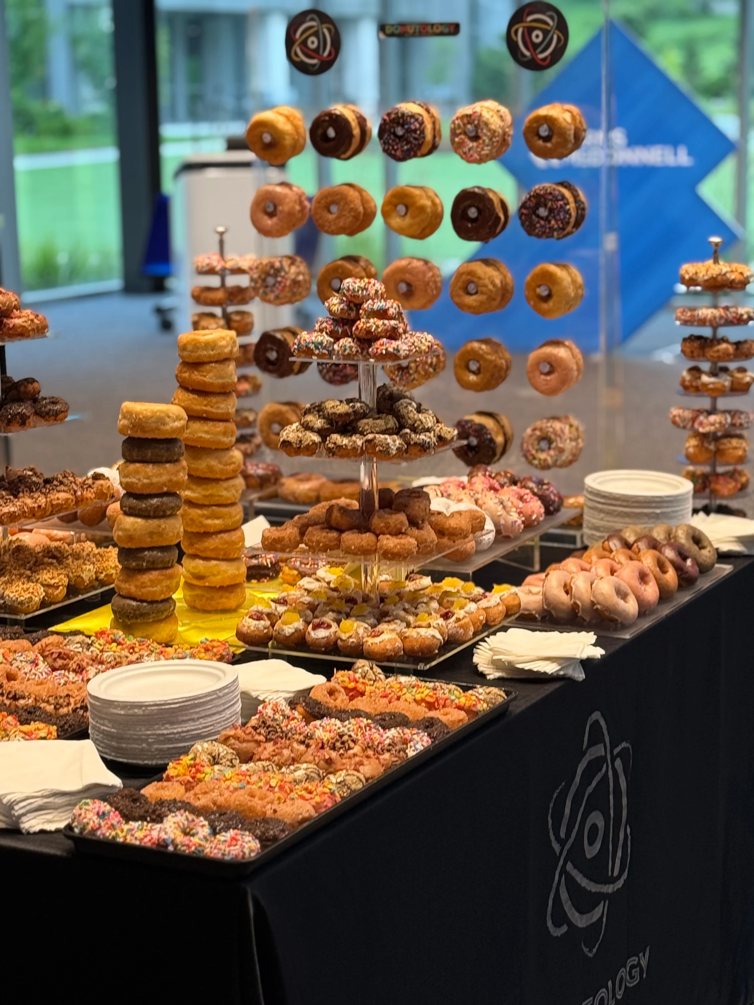 Assorted gourmet donuts displayed on a dessert table