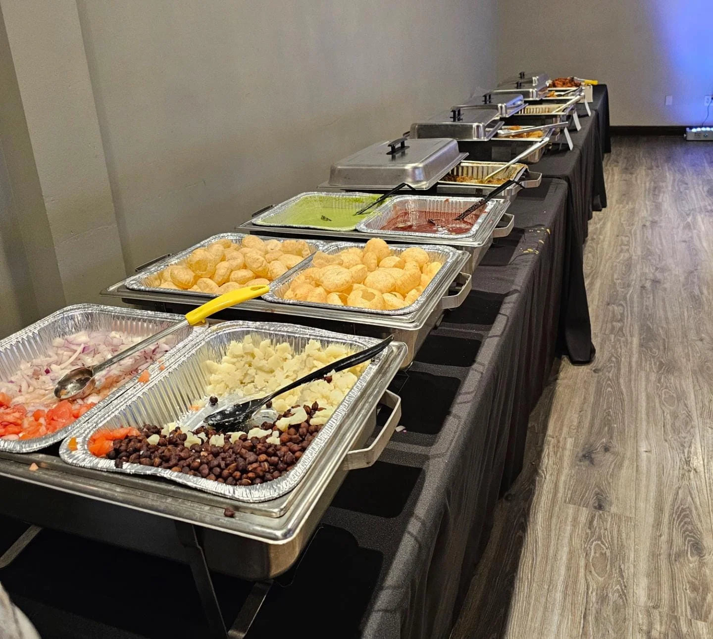 Indian street food buffet with pani puri and assorted toppings