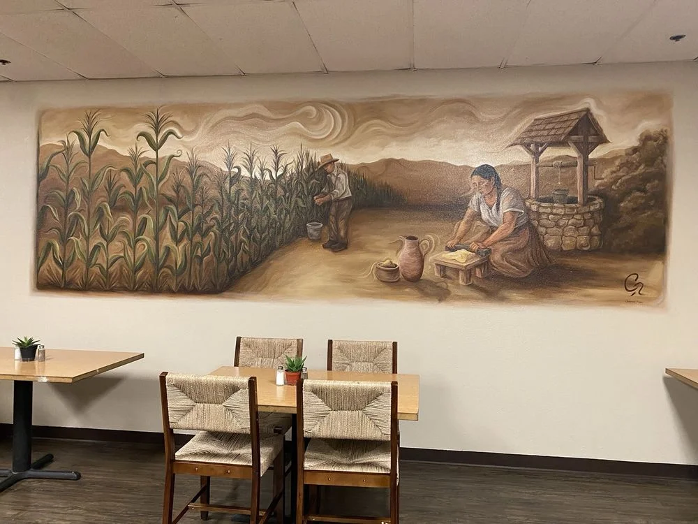 Mural depicting traditional farming scene in a rustic restaurant
