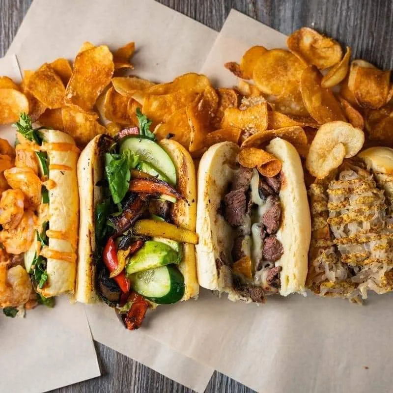Gourmet hot dogs with assorted toppings and crispy potato chips