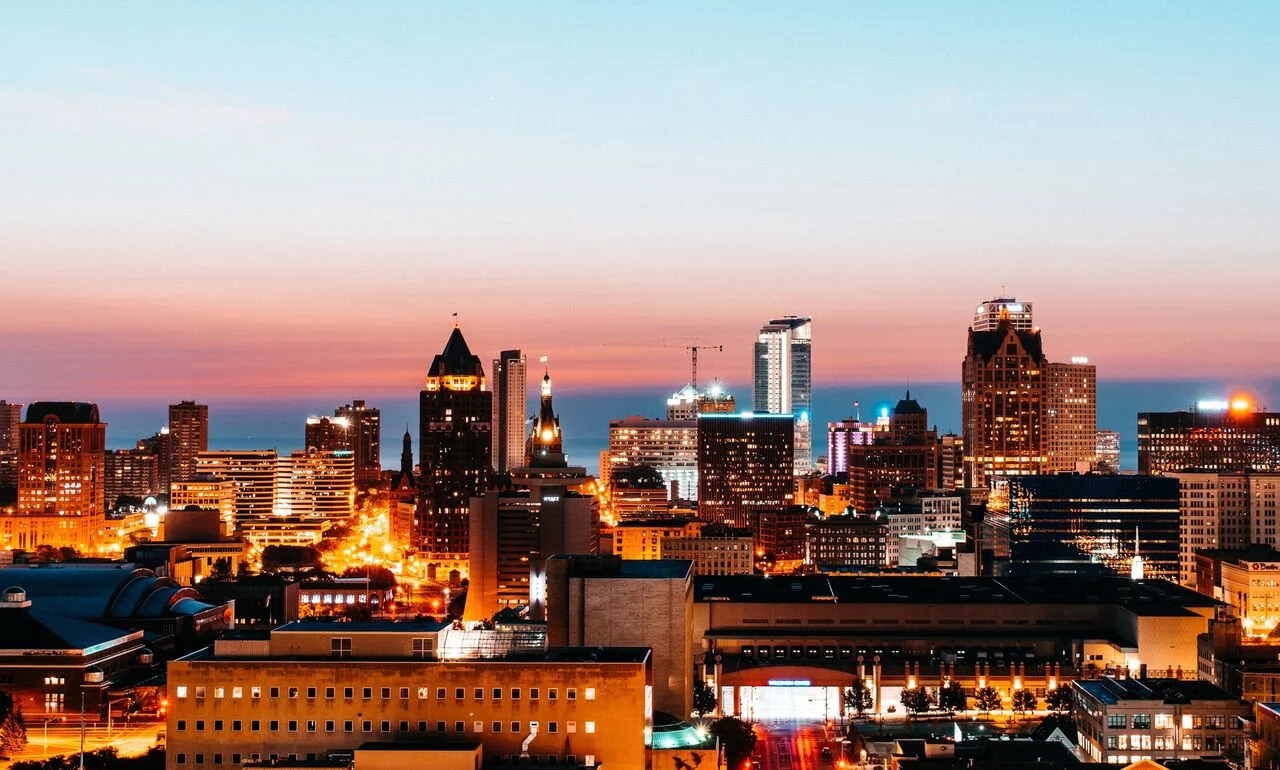 Milwaukee skyline at sunset with vibrant city lights