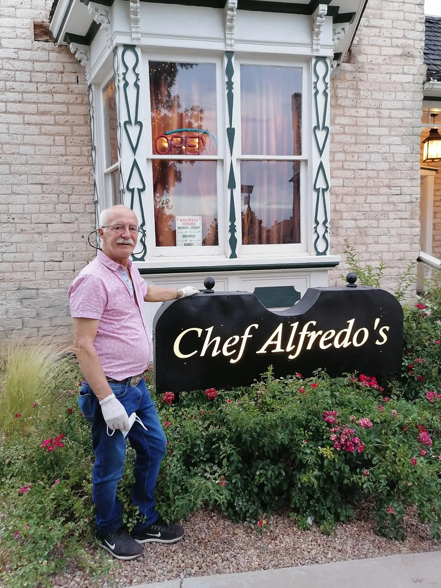 Owner welcoming guests at Chef Alfredo's restaurant entrance