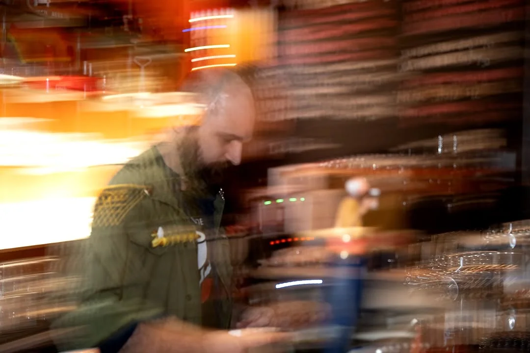 Bartender in motion preparing drinks in a vibrant bar setting