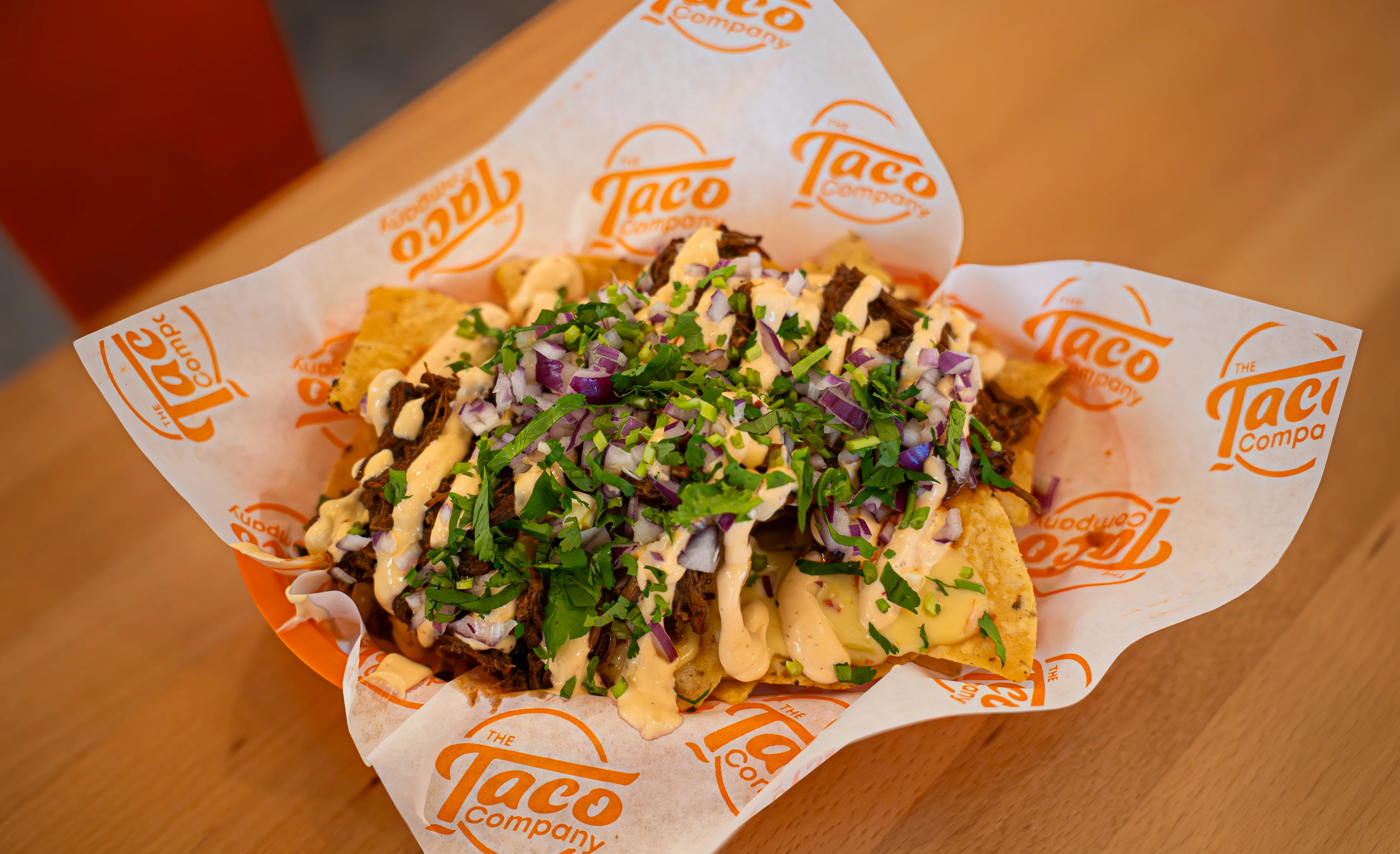 Loaded nachos topped with beef and fresh herbs