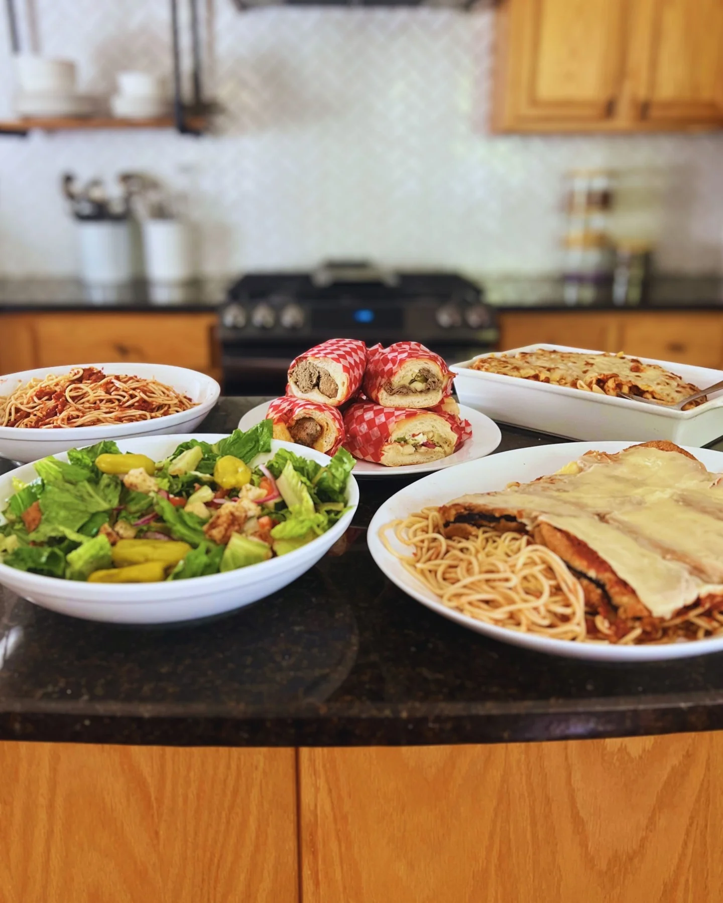 Italian feast featuring lasagna, spaghetti, and meatball subs