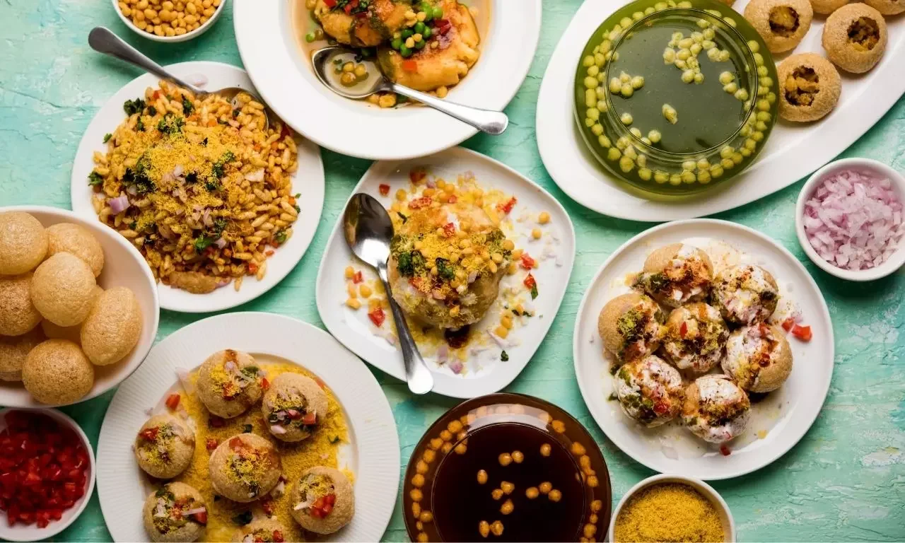 Assorted Indian street snacks including pani puri and bhel puri