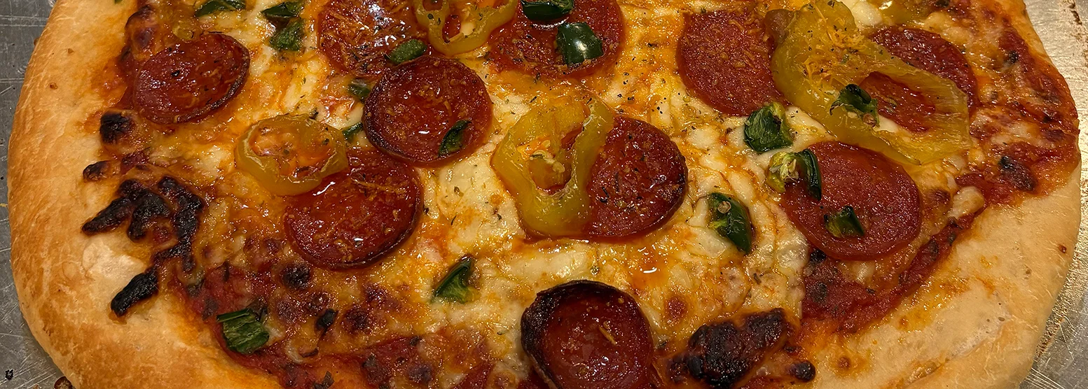 Pepperoni pizza with jalapeños and melted cheese
