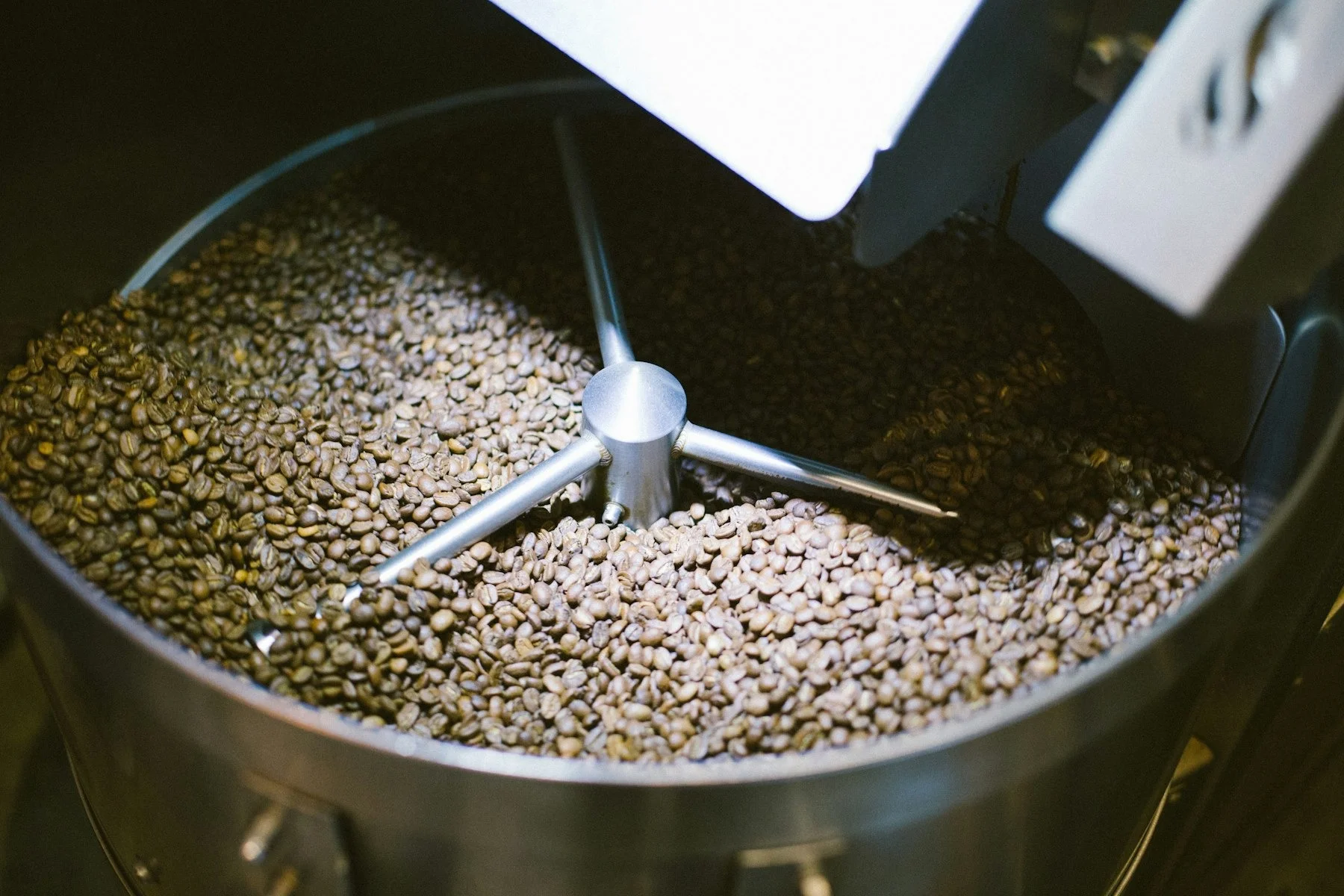 Freshly roasted coffee beans in a roasting machine