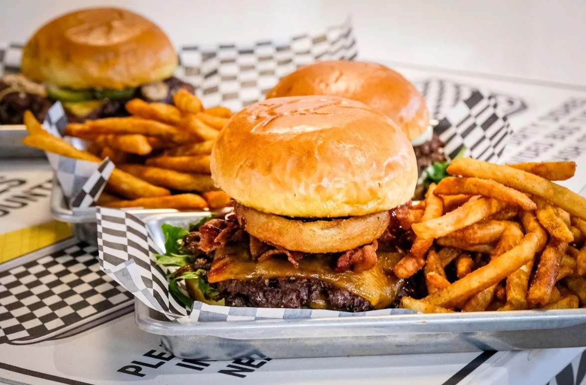 Juicy American cheeseburger with fries and crispy onion rings