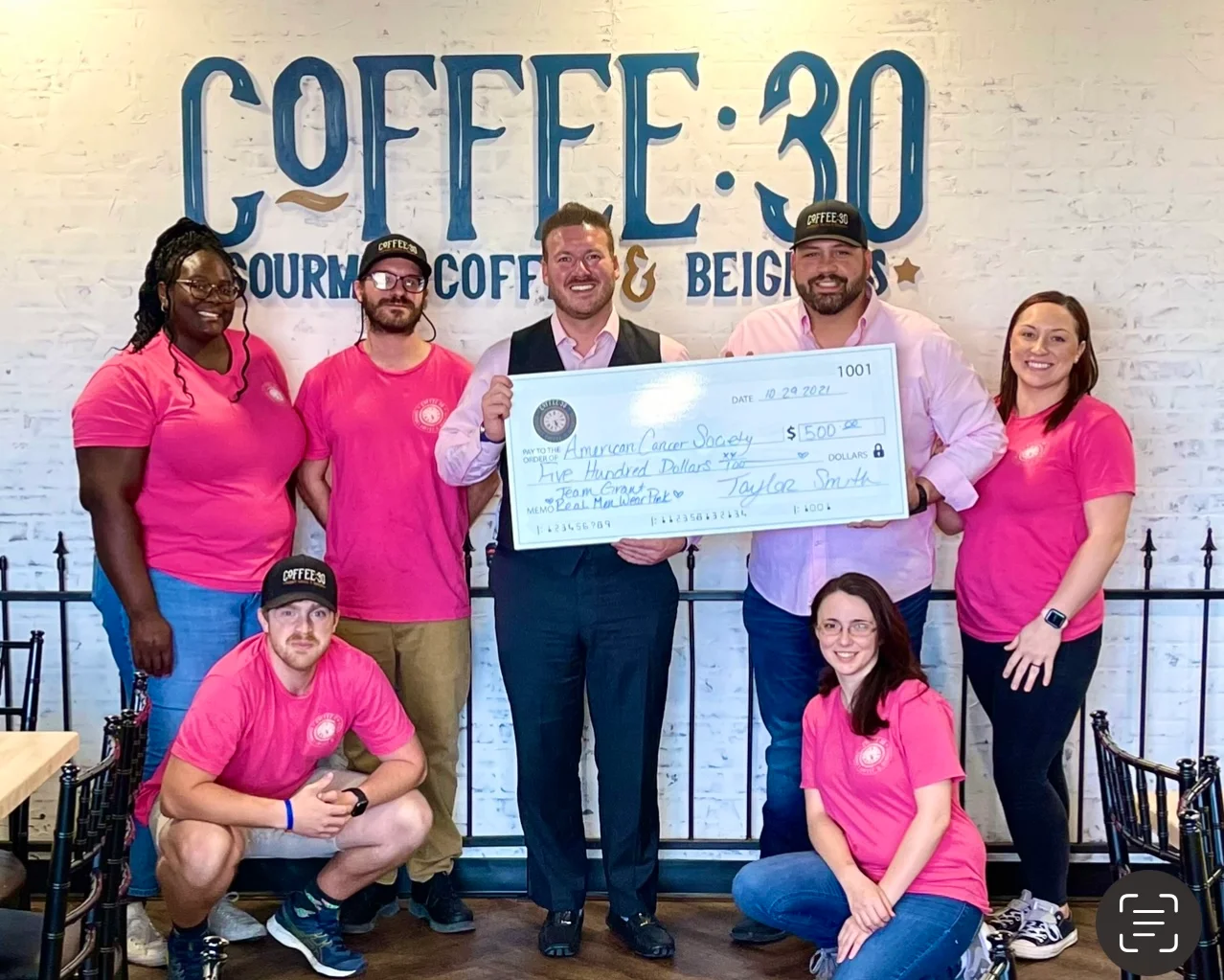 Team presenting a donation check to American Cancer Society at Coffee:30