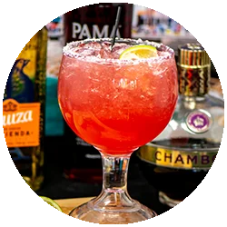 Colorful cocktail garnished with lime in a stylish glass