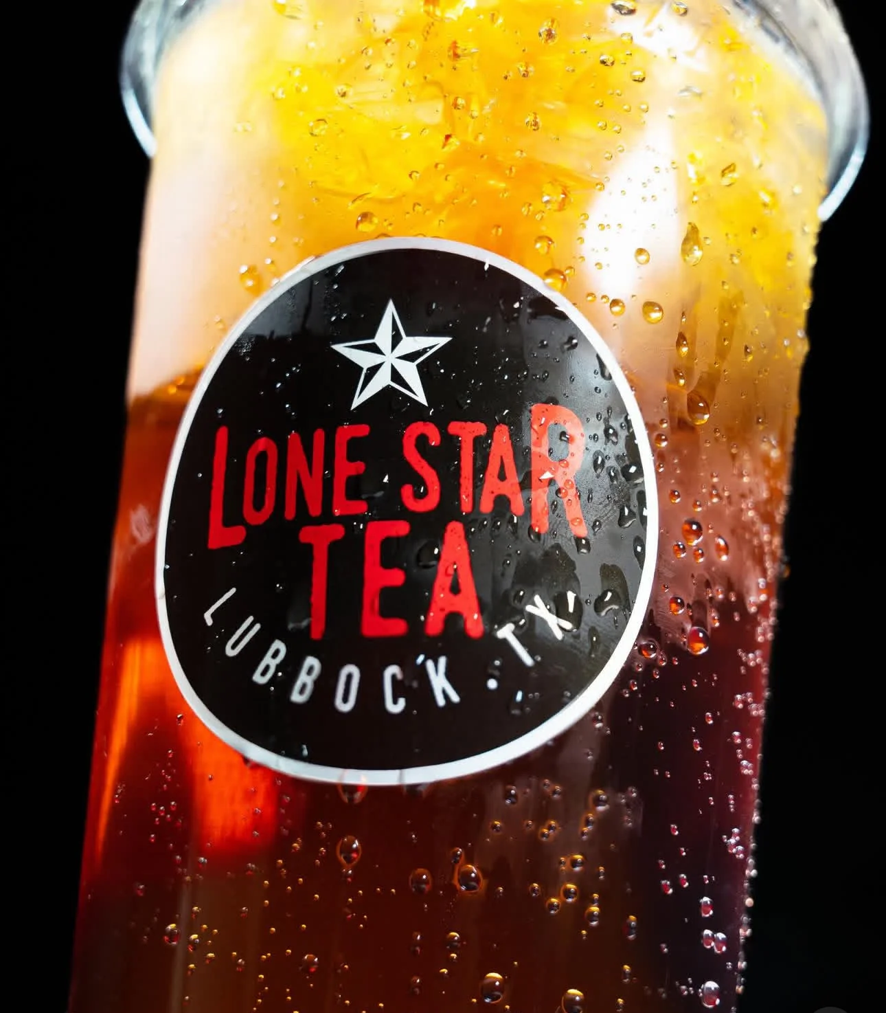 A refreshing iced tea served in a glass with lemon and mint garnish.