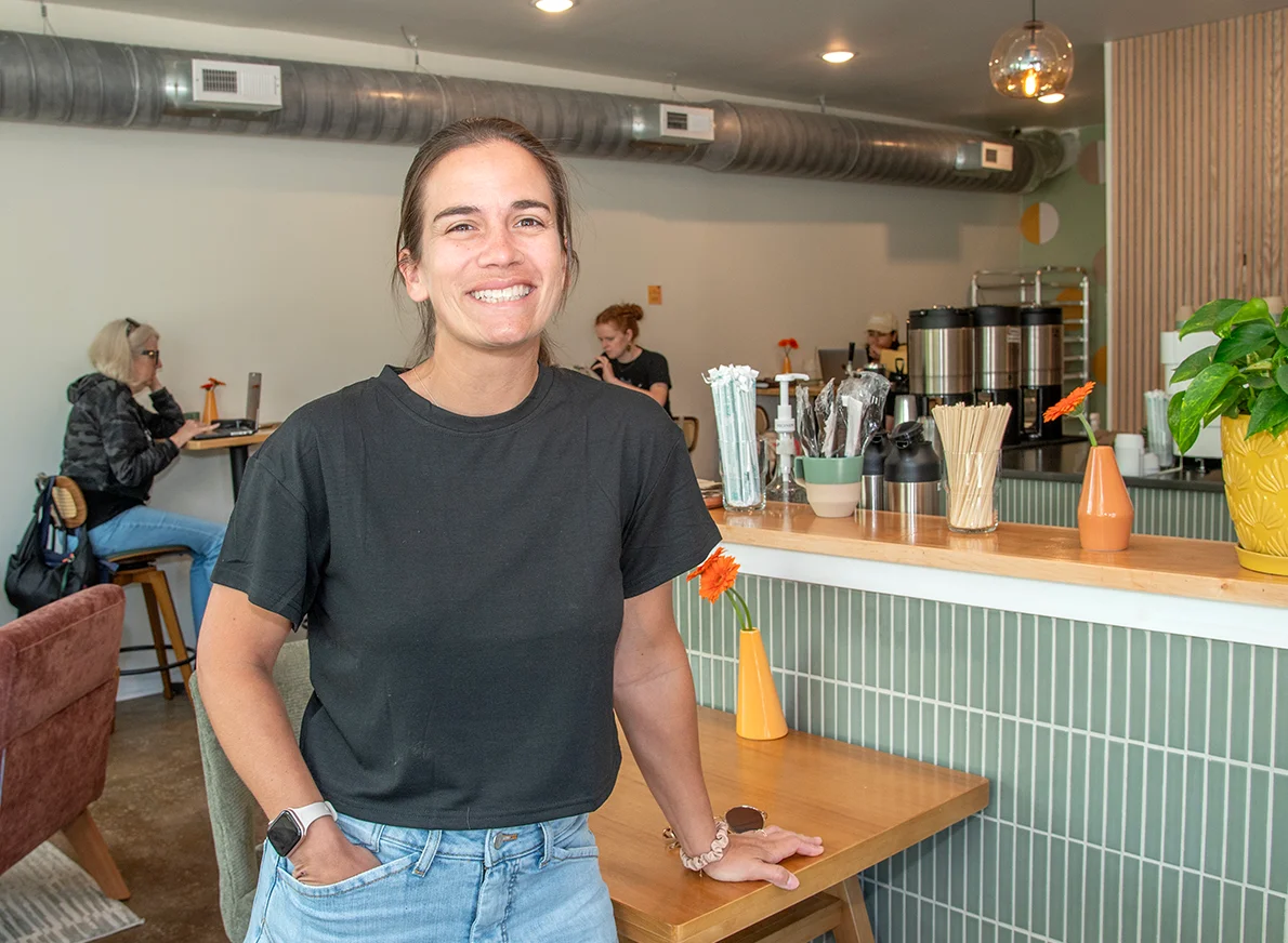 Smiling restaurant owner in a cozy café interior