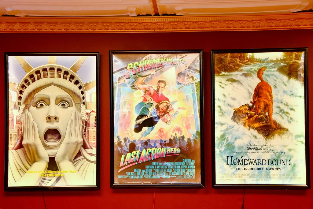 Movie posters featuring iconic films on a red wall