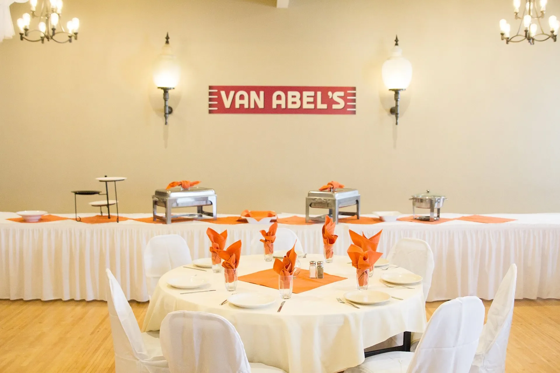 Elegant restaurant dining setup with orange accents