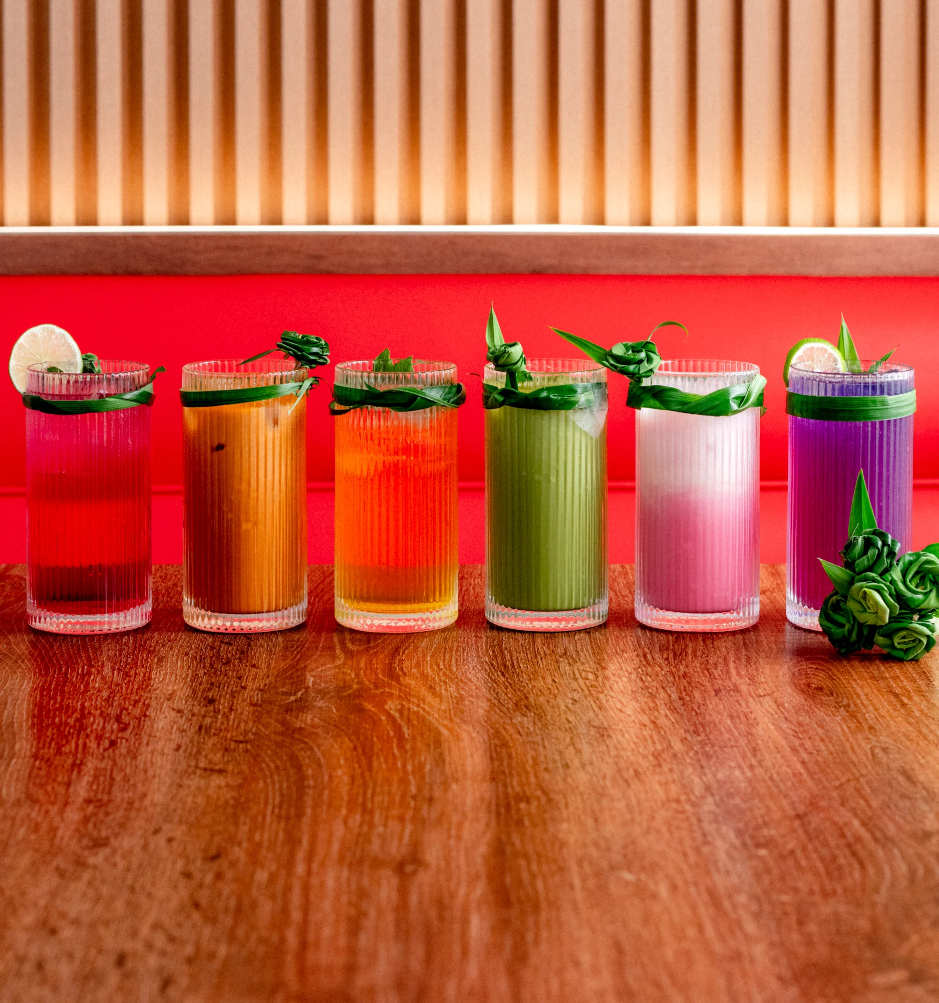 Colorful cocktails in tall glasses with garnishes