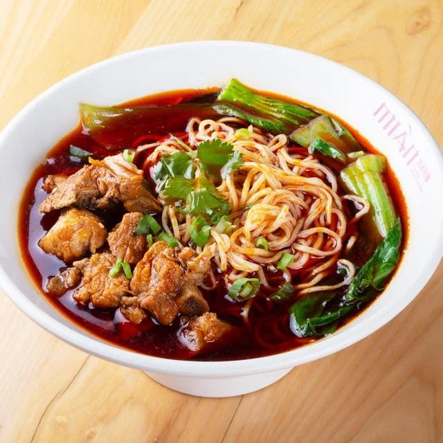 Delicious spareribs served with noodles on a plate.