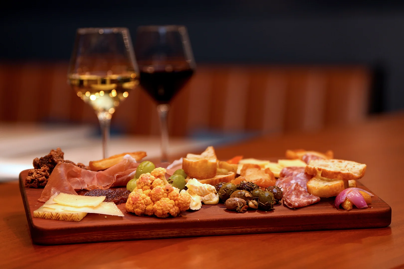 Charcuterie board with wine in a modern dining setting