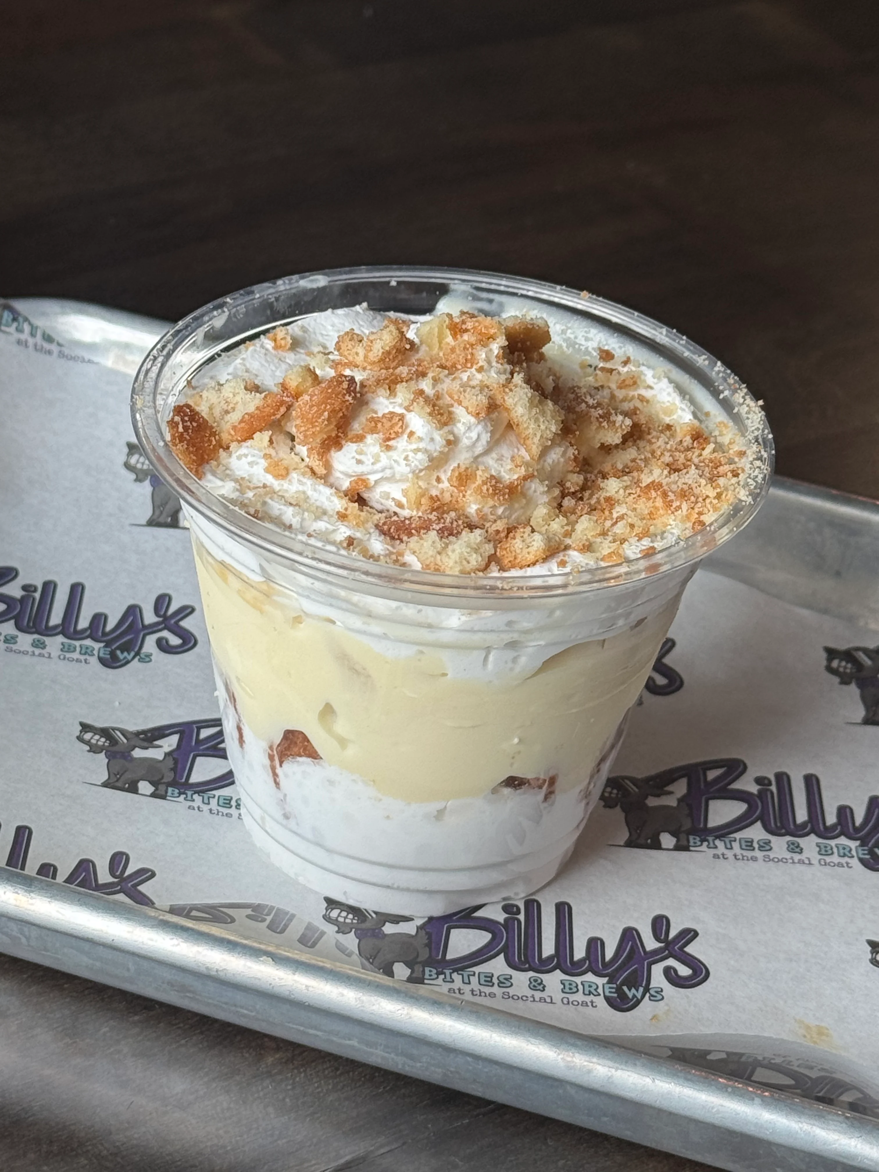 Delicious banana pudding dessert in a clear cup with whipped cream