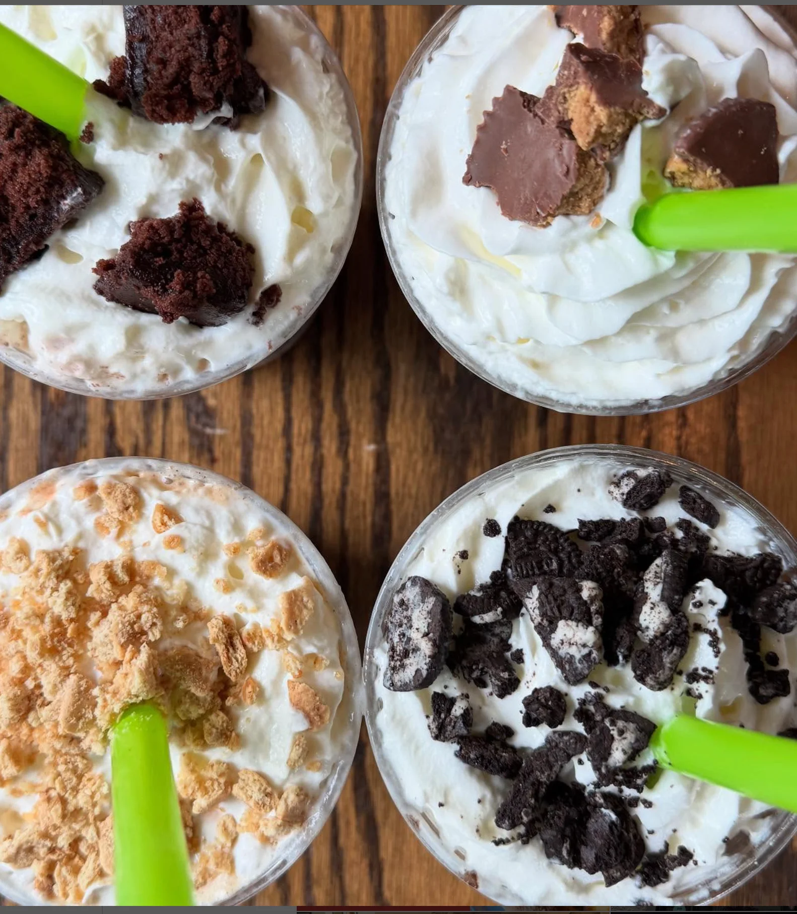 Decadent milkshakes topped with whipped cream and chocolate treats