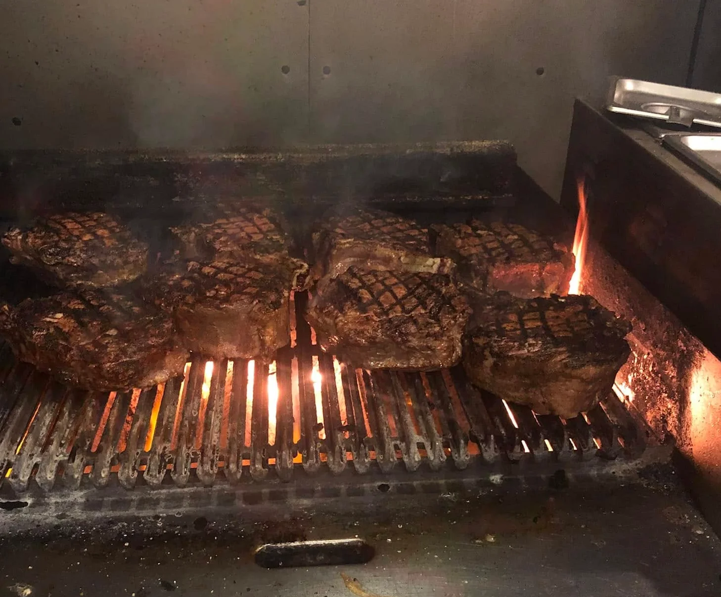 Grilled ribeye steaks sizzling on a barbecue