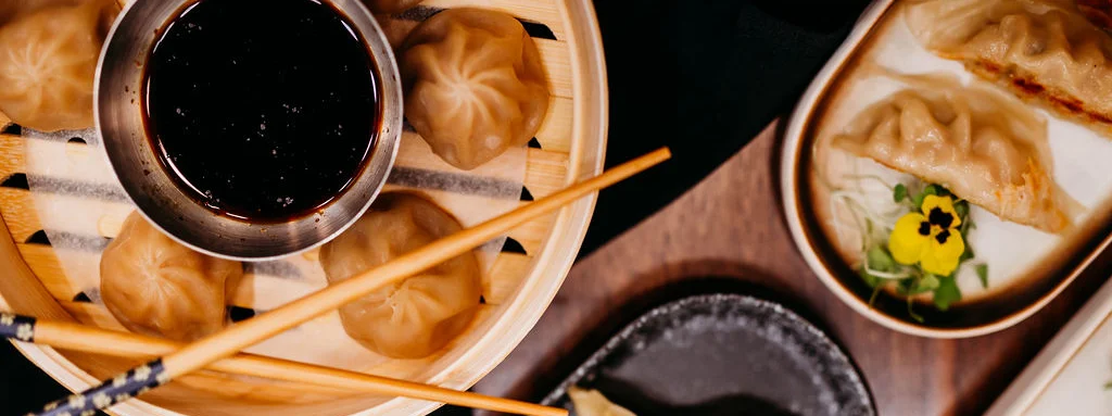 Assorted dumplings and gyoza served with dipping sauce