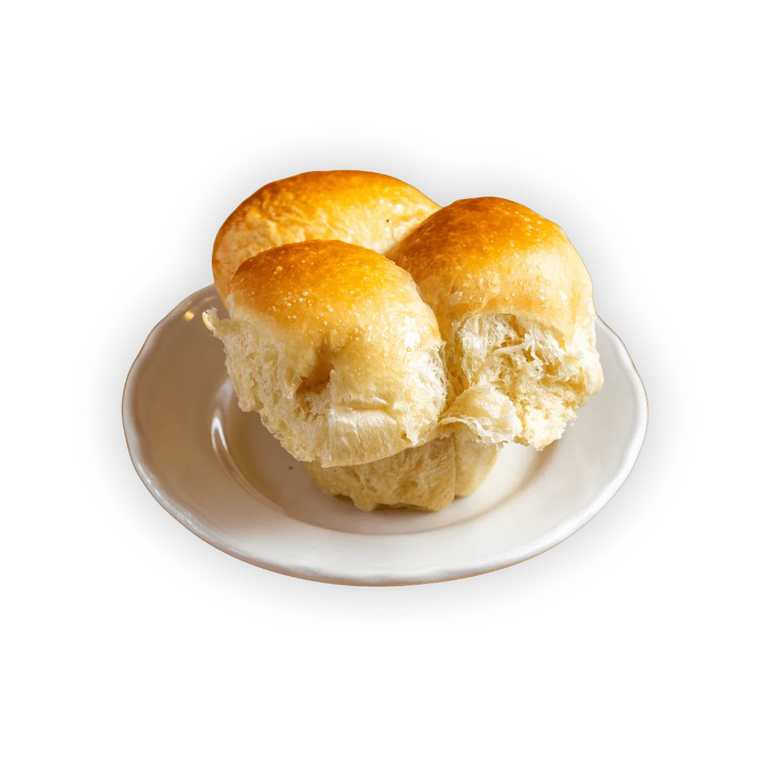 Freshly baked bread on a wooden table with a rustic background.