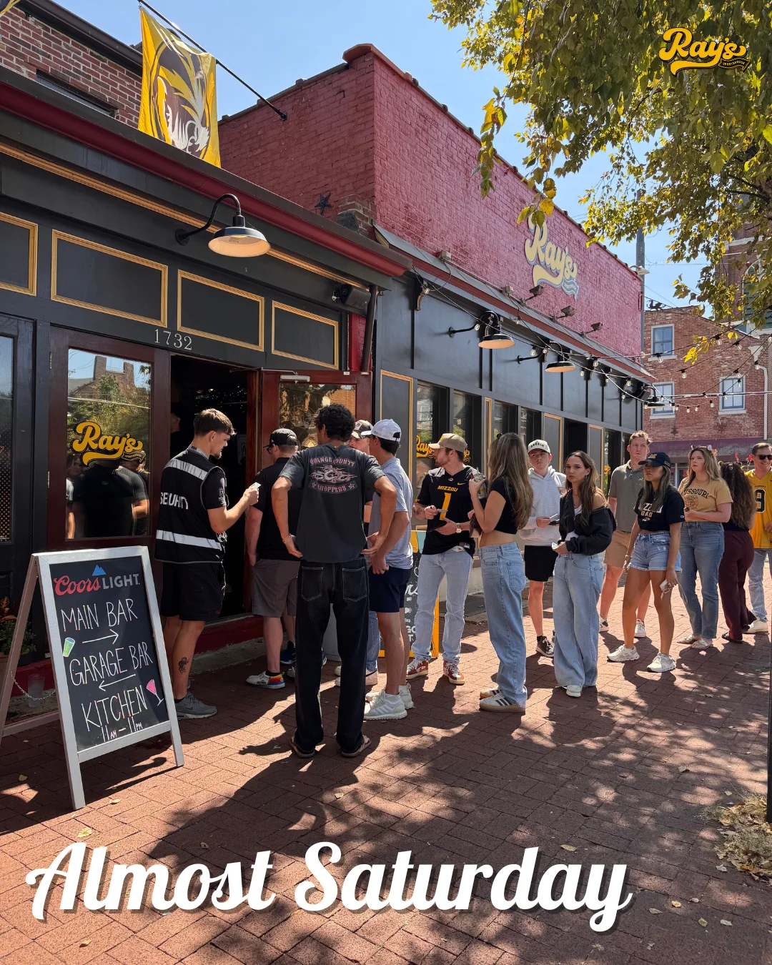 Crowd waiting outside Ray's restaurant on a sunny day