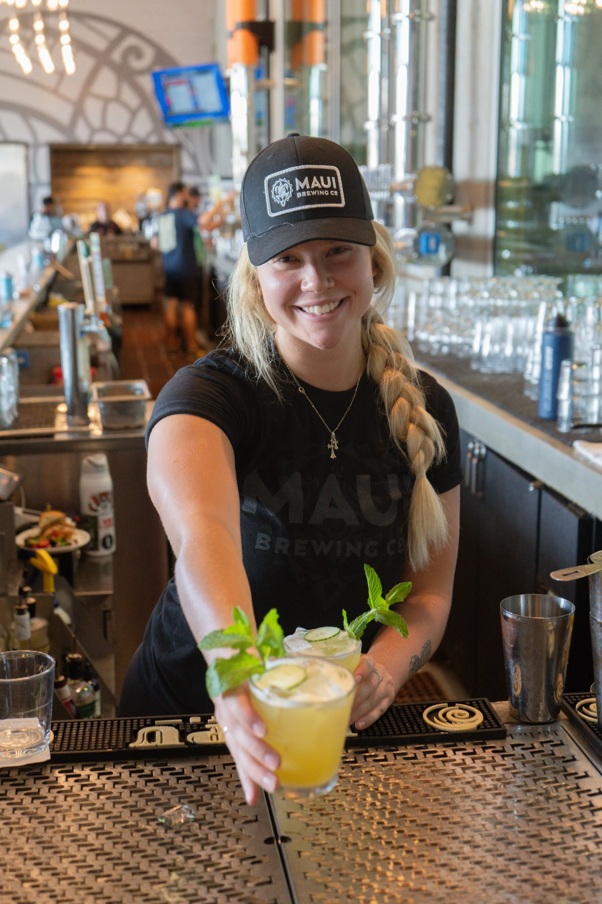 Bartender serving cocktails at a vibrant bar