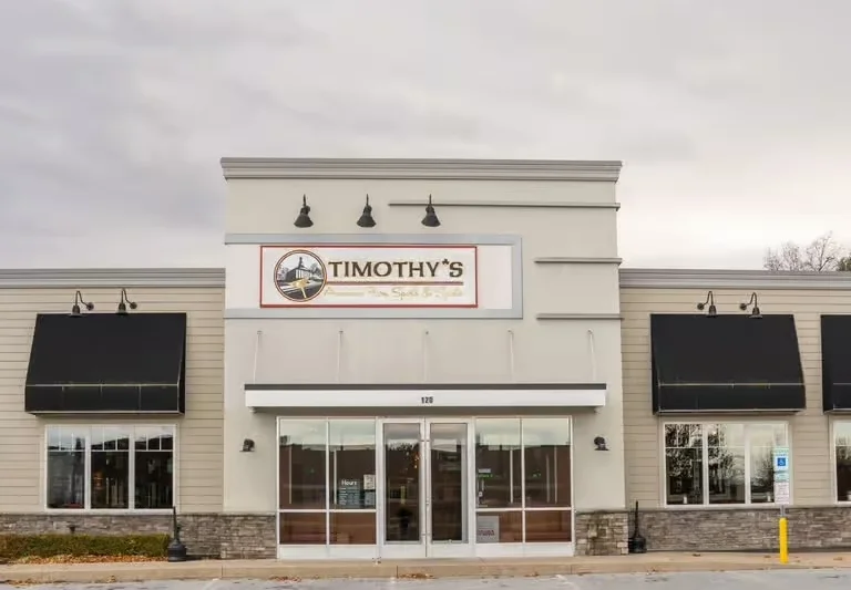 Modern restaurant storefront with prominent signage and covered entrance
