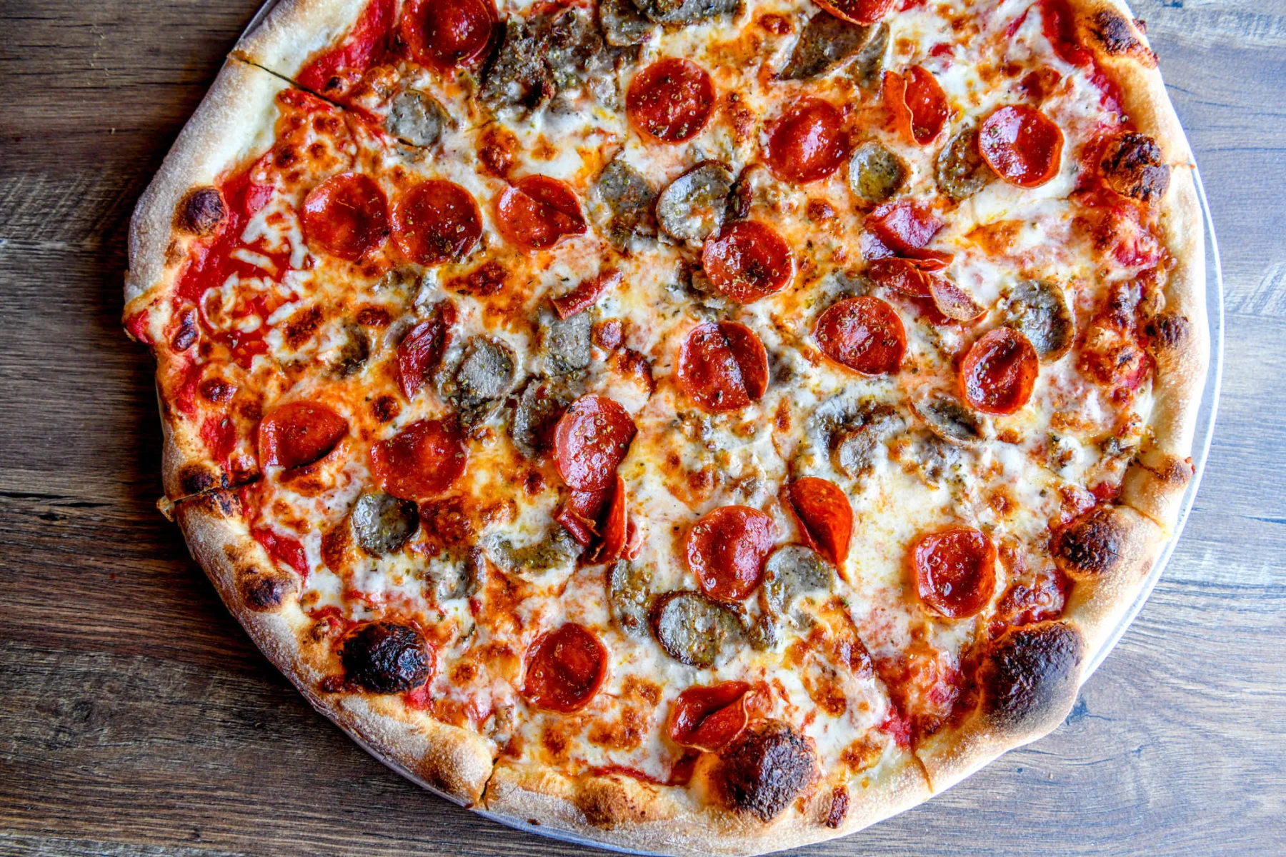 Classic pepperoni and sausage pizza from a pizzeria