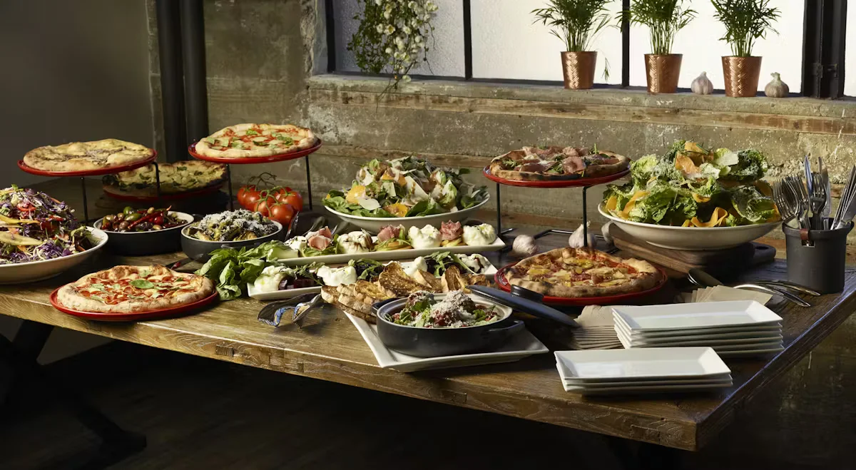 a spread of different menu pizza salad 
