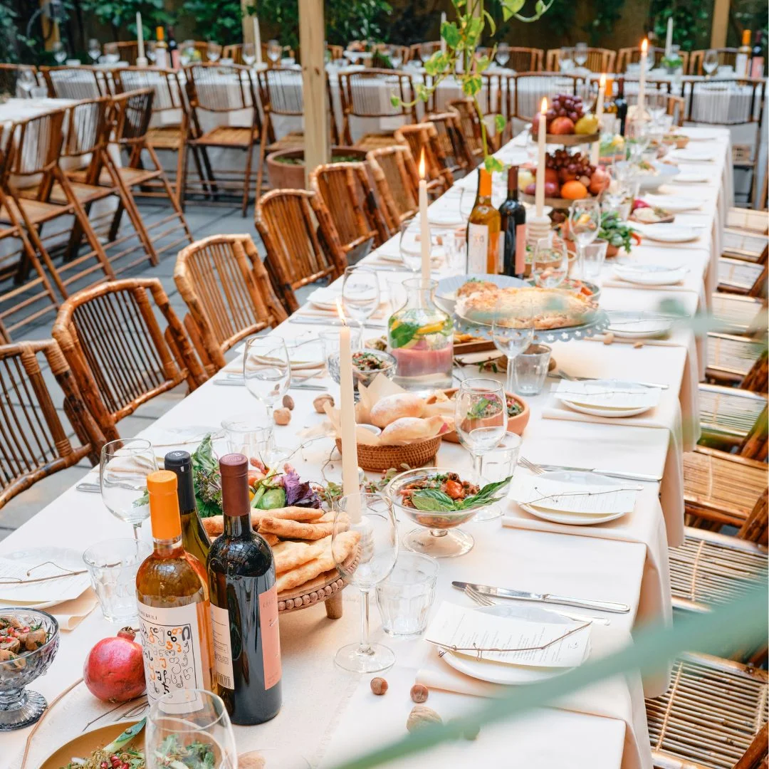 Long celebration table set with wine and flowers