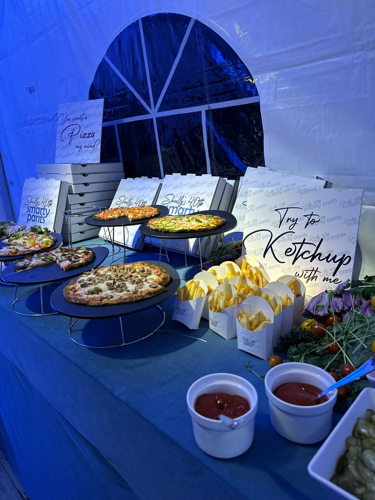 Assorted pizzas and fries at a festive event