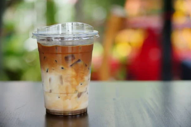 Iced coffee drink with layered milk and espresso in a clear cup