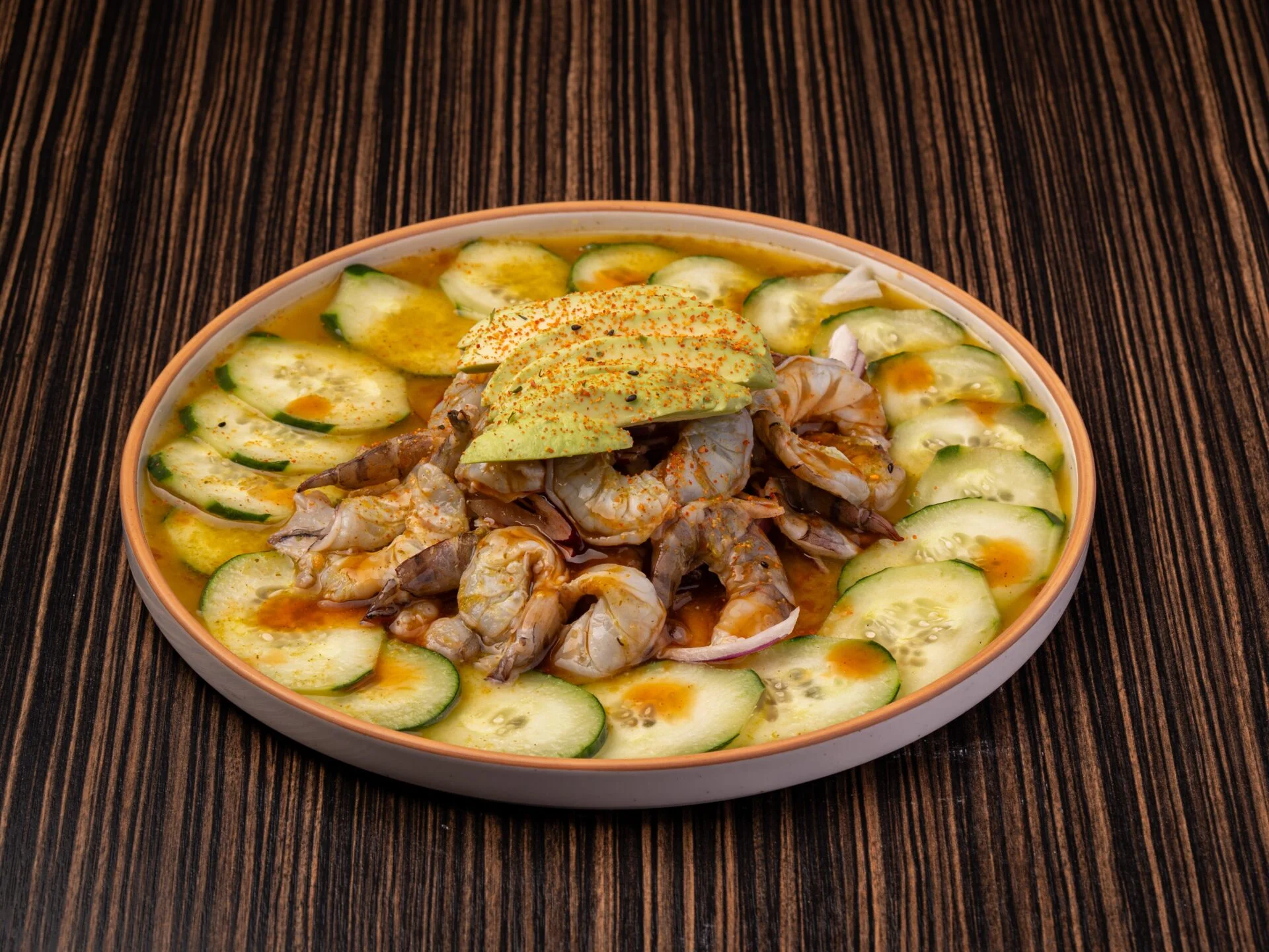 Ceviche de camarón with avocado and cucumber slices