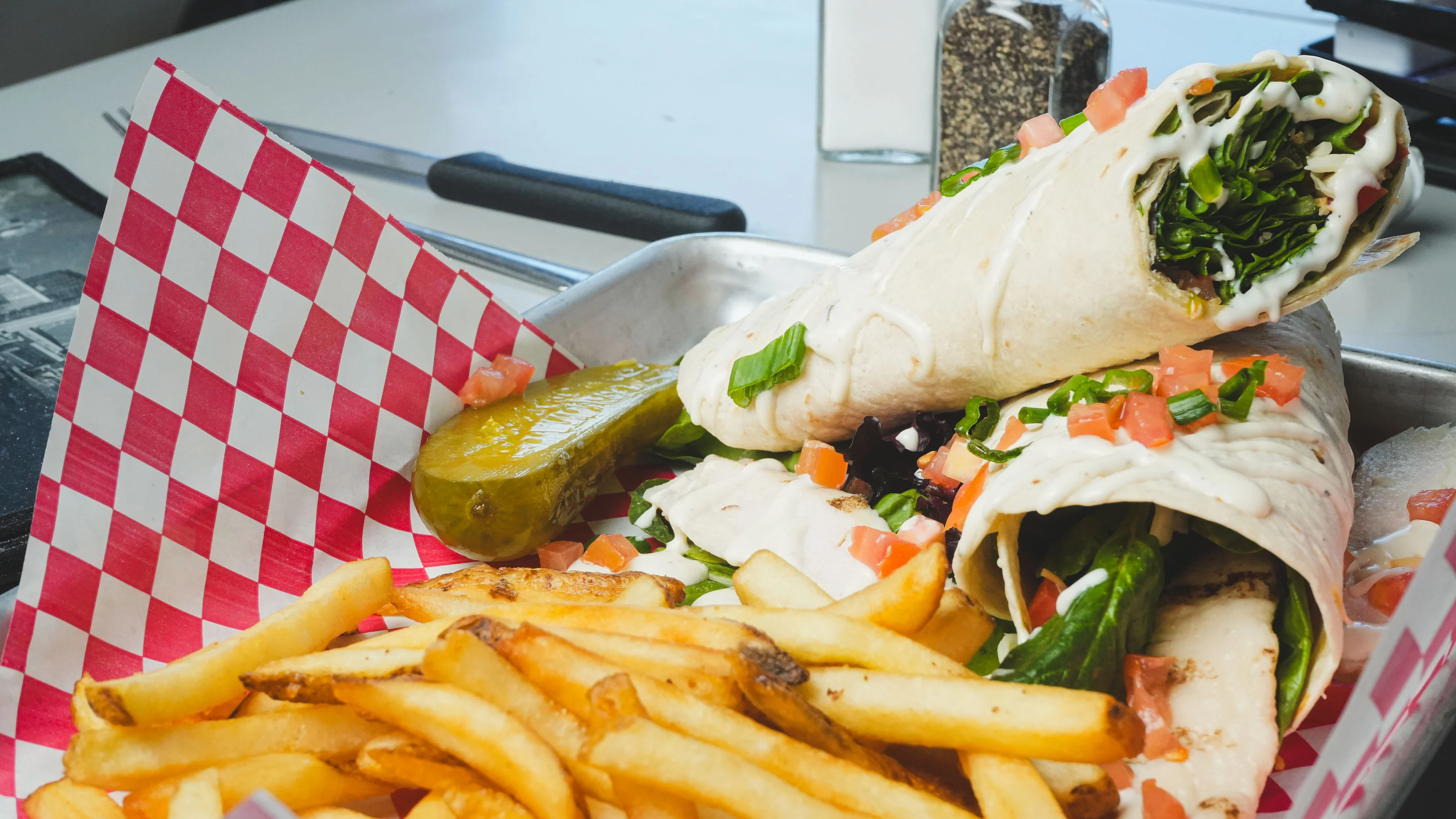 Fresh wraps with greens and fries served in a diner