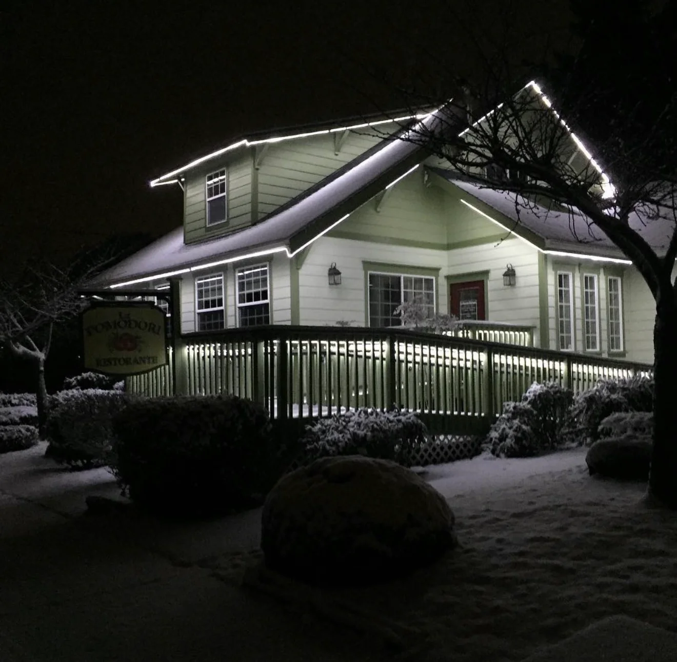 Charming restaurant exterior illuminated in winter snow