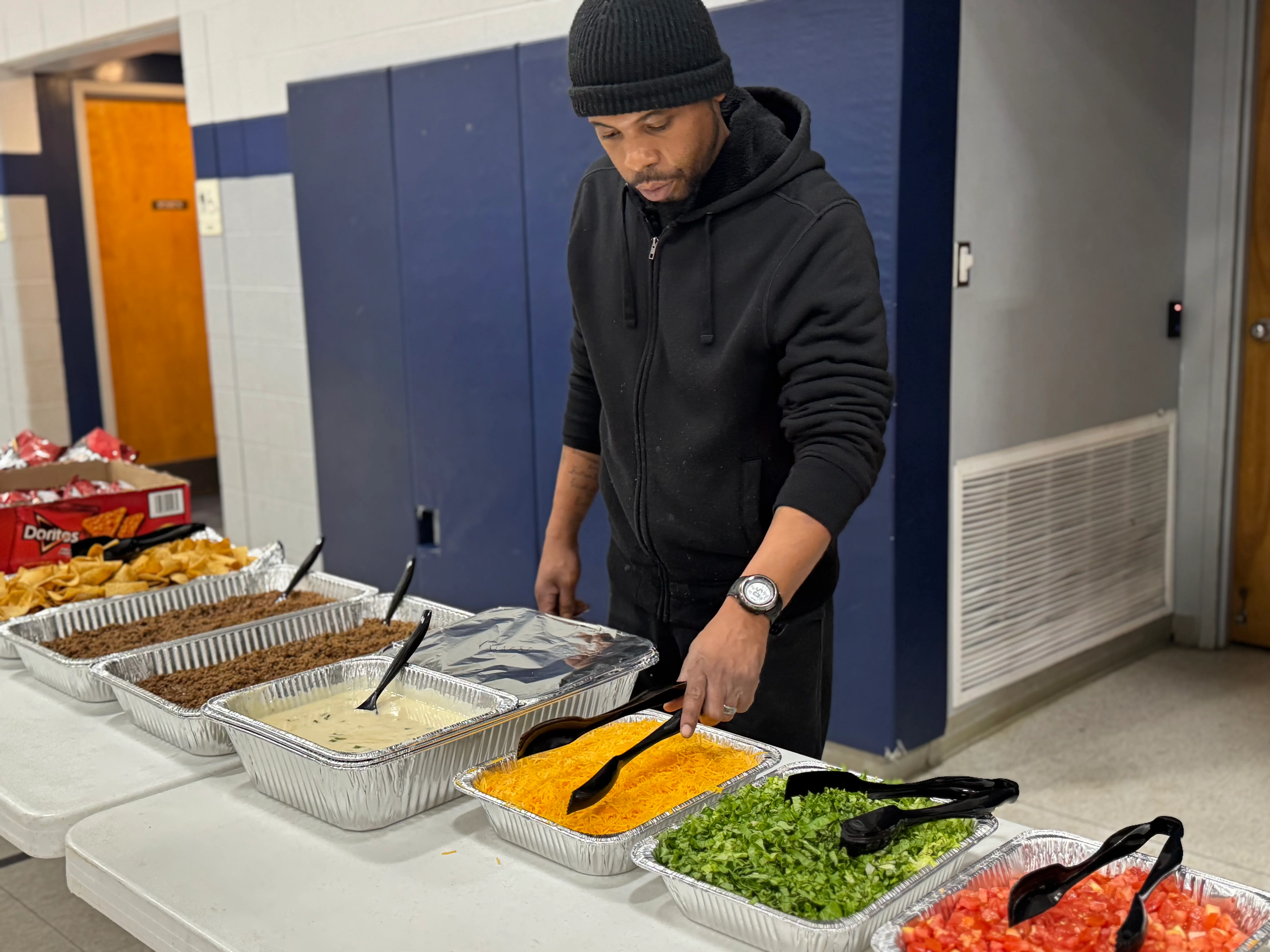 Taco bar setup with toppings and nacho chips