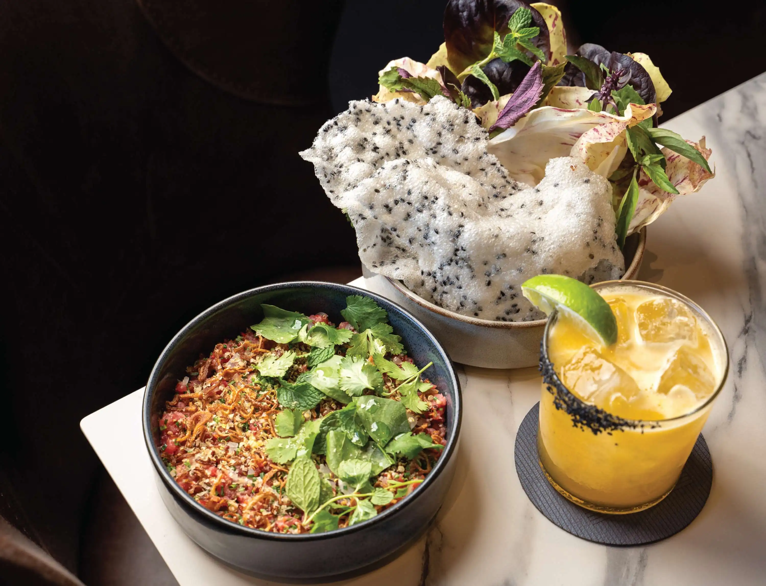 BEEF TARTARE* Toasted Quinoa, Pickled Ramps, Crispy Shallots, Thai Chilies, Cured Egg Yolk, Sesame-Rice Crackers, Watercress, Lettuces, and Herbs.