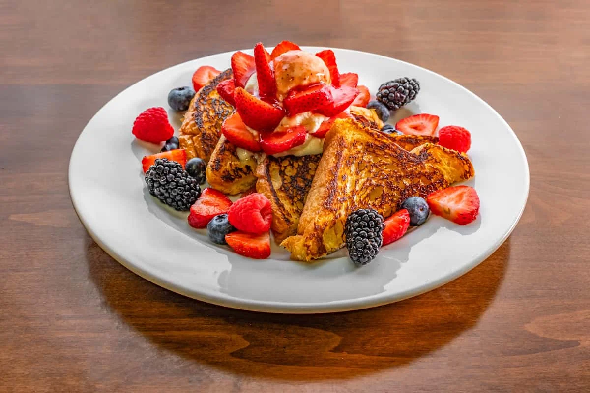 French toast topped with fresh berries and ice cream