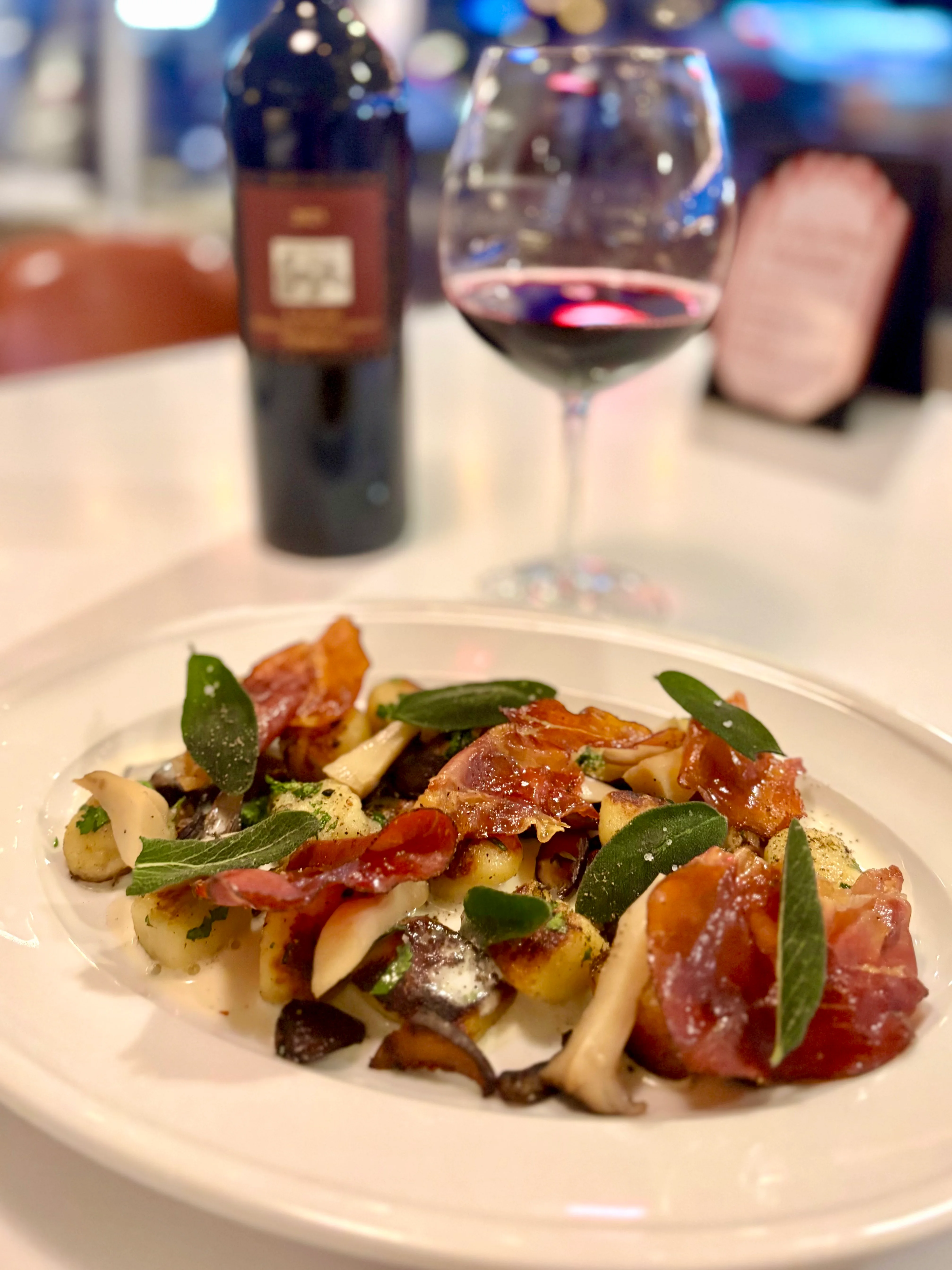 Gnocchi with prosciutto and sage in an Italian restaurant setting