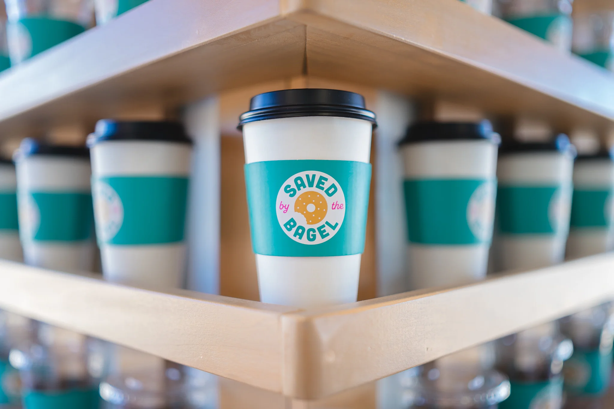 Coffee cup with Saved by the Bagel sleeve