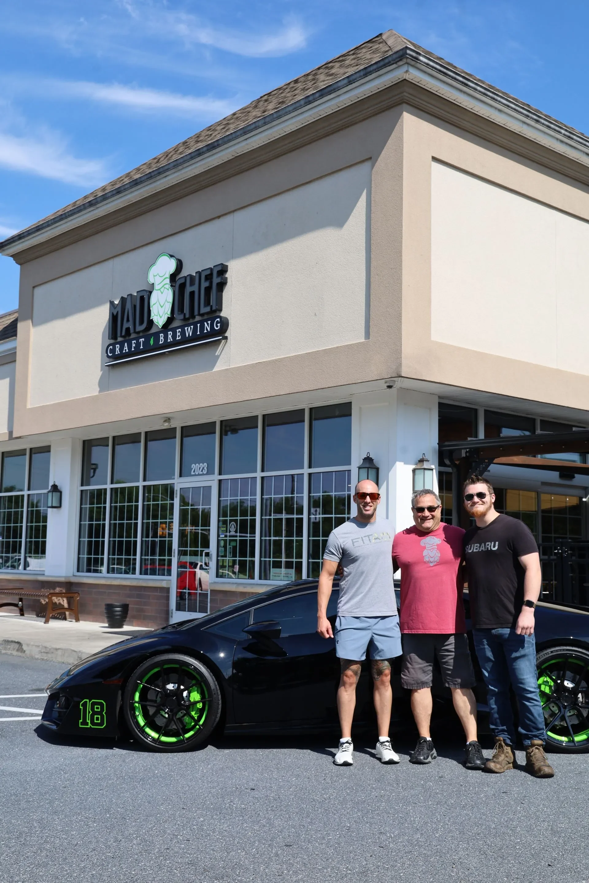 Exterior view of Mad Chef Craft Brewing with a sports car