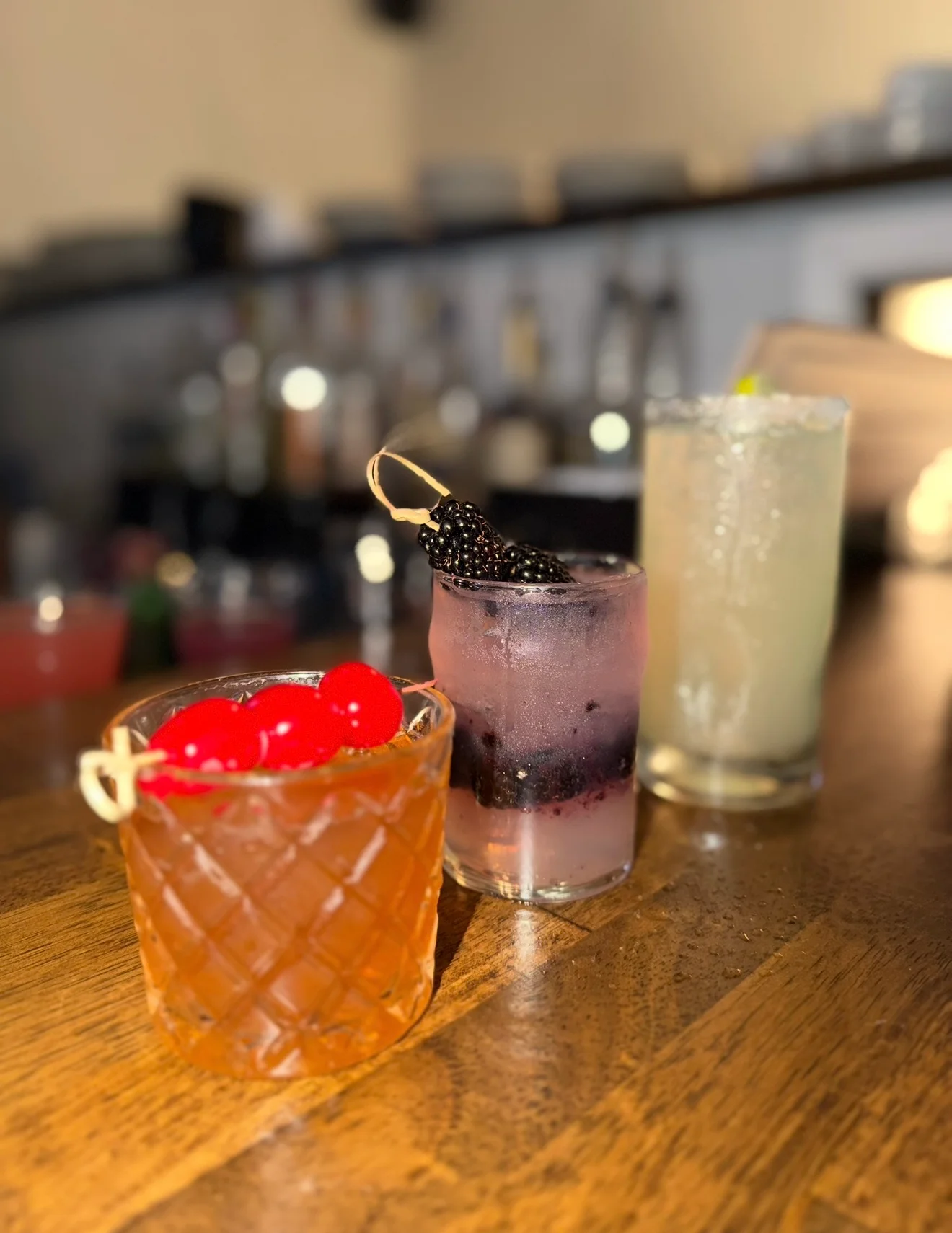 Colorful cocktails on a wooden bar counter