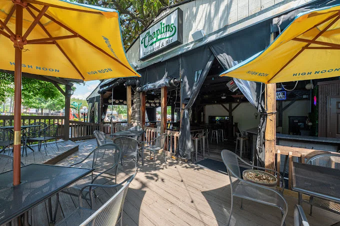 Outdoor dining area of Chaplin's restaurant with yellow umbrellas