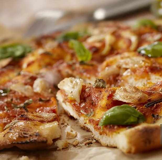 Freshly baked Margherita pizza with basil