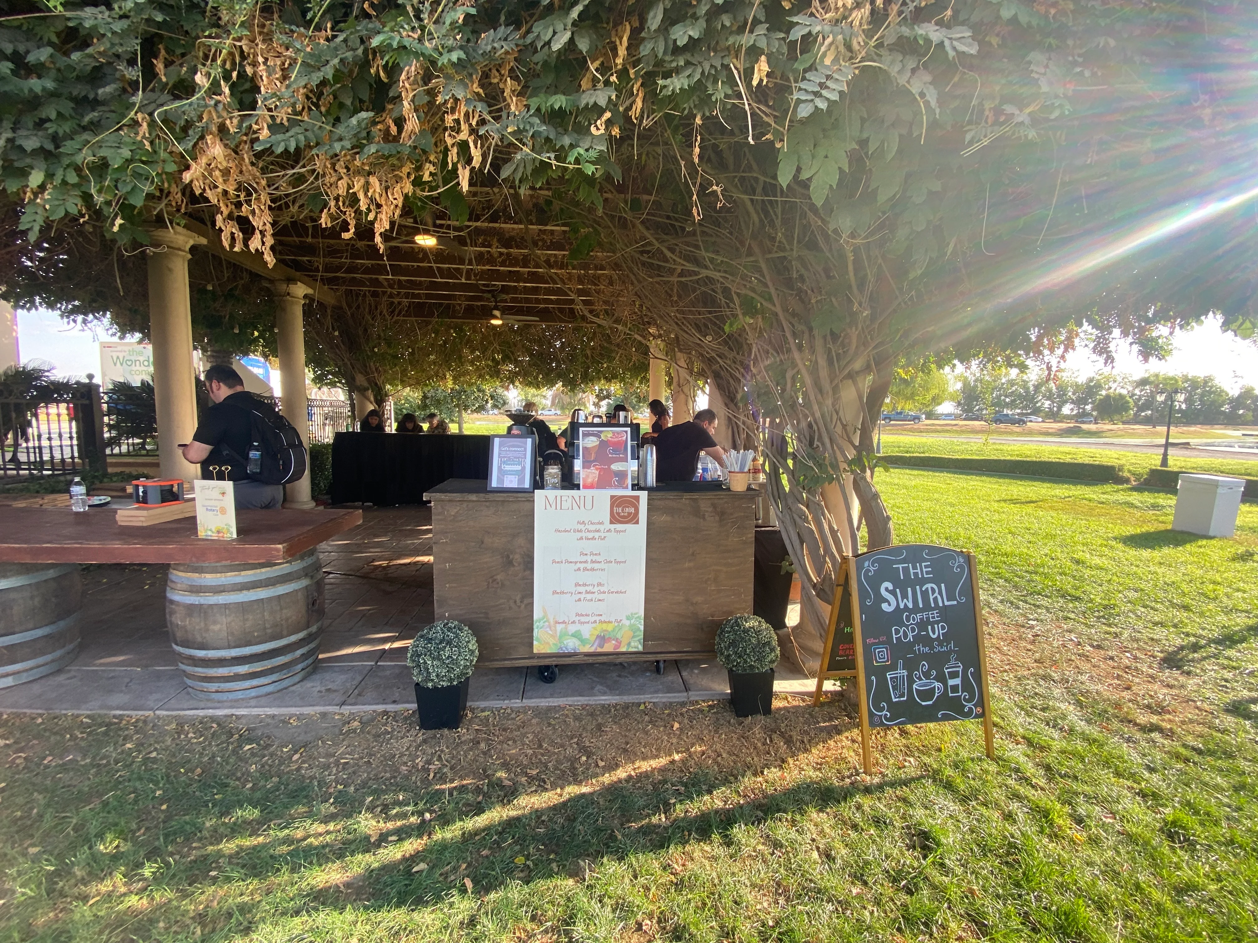 Outdoor coffee pop-up stand with menu and seating area